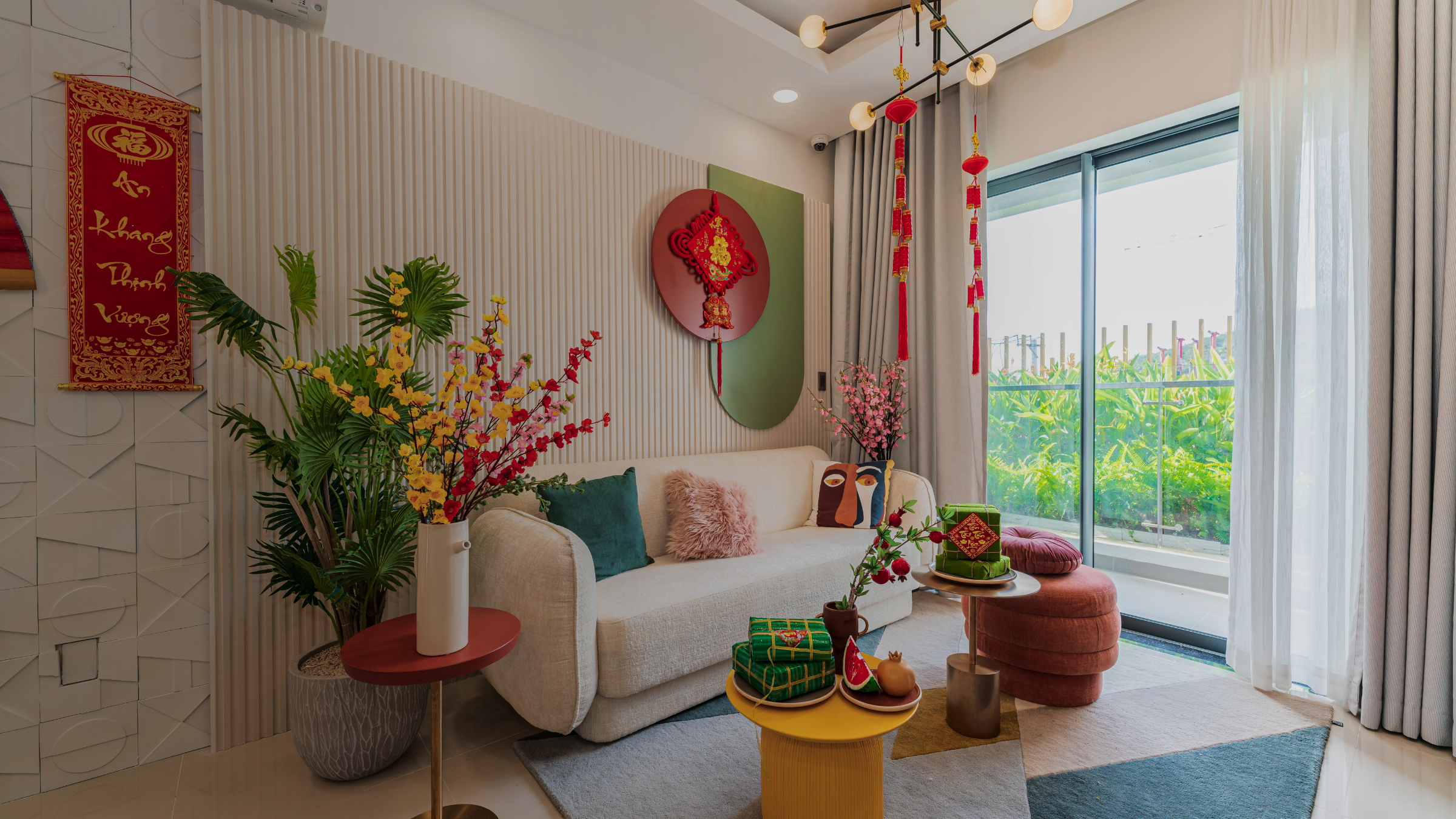 Festive Vietnamese Tet living room with lucky red decorations, apricot blossoms, gift boxes, modern beige sofa, and vibrant accents