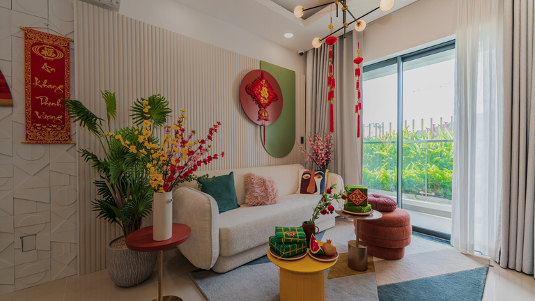 Festive Vietnamese Tet living room with lucky red decorations, apricot blossoms, gift boxes, modern beige sofa, and vibrant accents
